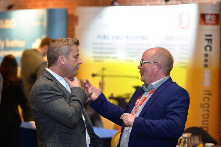 A speaker and an attendee converse over coffee Construction Frameworks Conference, Kensington Town Hall. 02.10.19