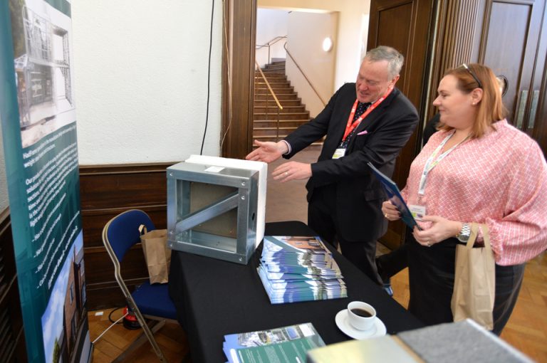 HadFrame Construction Showcasing their stand to an attendee