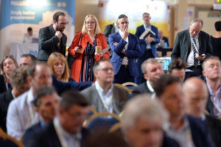 Attendee's stand watchinhg construction industry based Presentations West of England Development Conference, Bristol.08.10.19