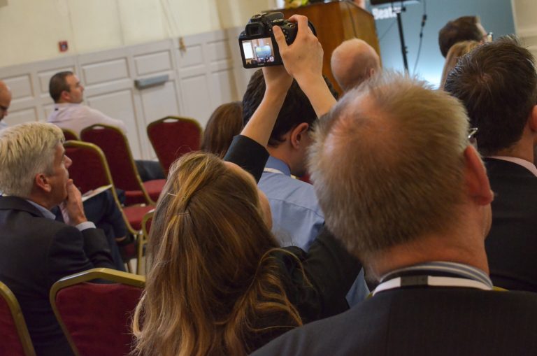 Attendee takes a picture of the Panel