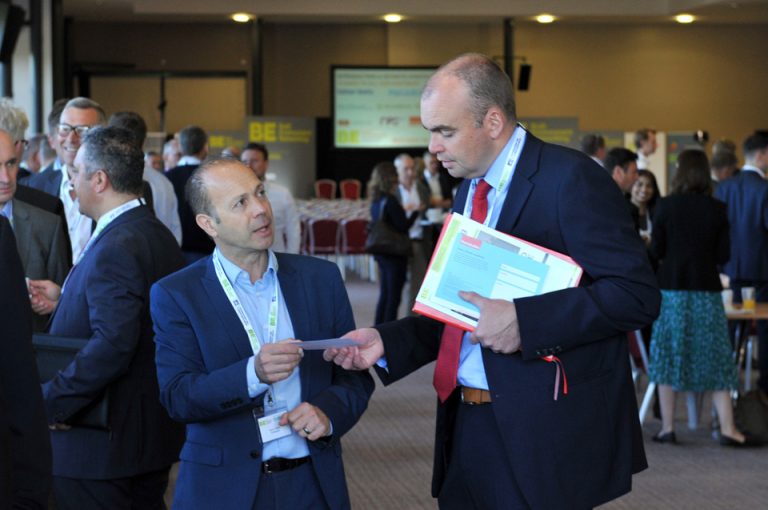 Attendee's exchange business cards at Oxford Cambridge Arc Development Conference 2019