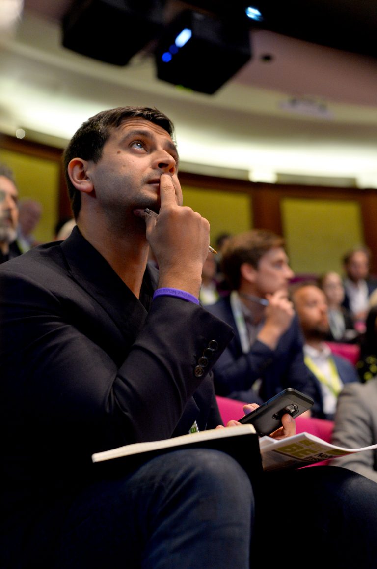 attendee's attentively watch on as the speakers present